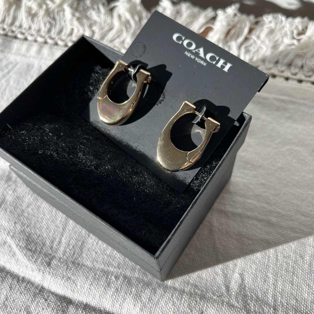 Coach chunky gold hoop earrings with “diamonds”